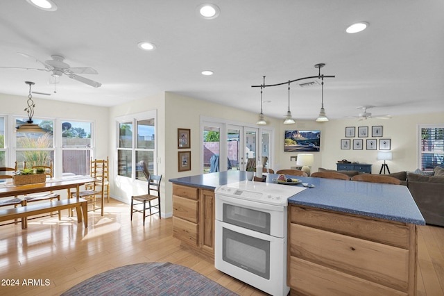 kitchen featuring pendant lighting, plenty of natural light, and stove