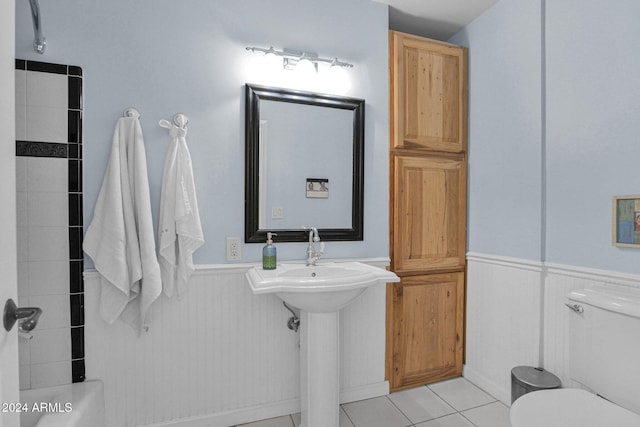 bathroom featuring sink, tile patterned flooring, and toilet