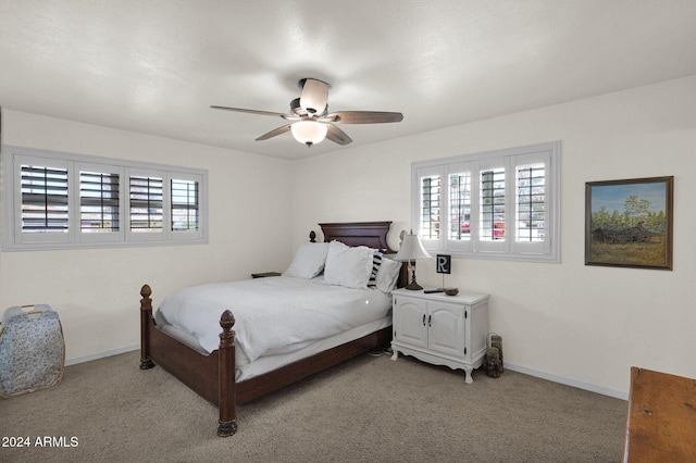 carpeted bedroom with multiple windows and ceiling fan