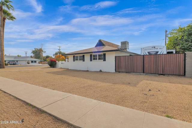 ranch-style house featuring central AC unit