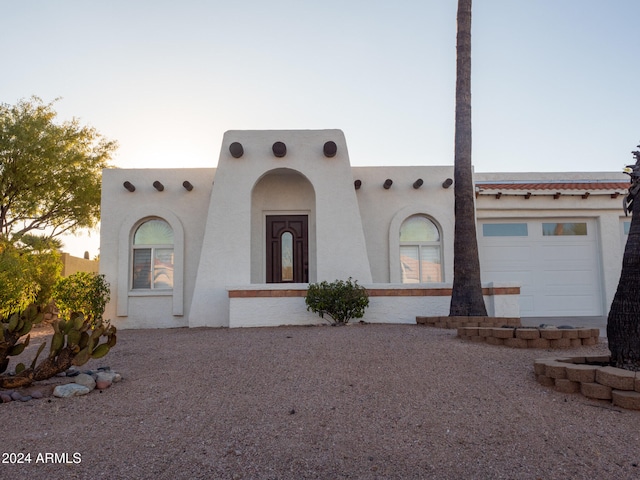 adobe home featuring a garage