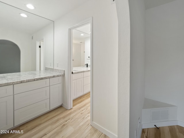 bathroom with hardwood / wood-style floors and vanity