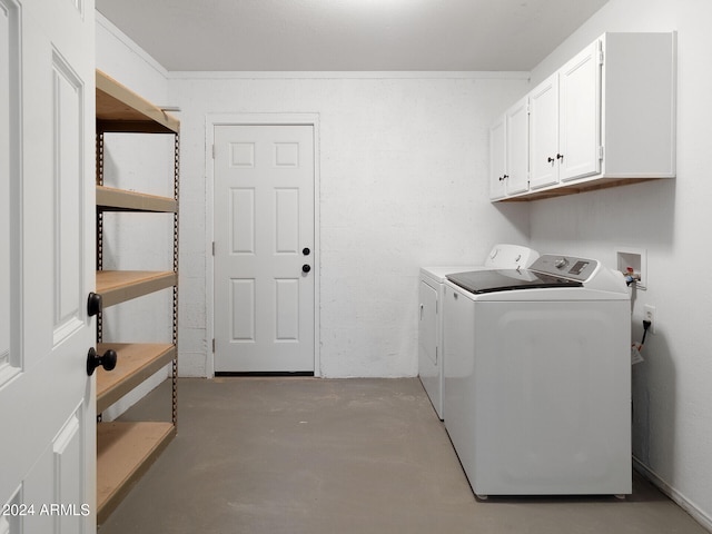 laundry room featuring washing machine and dryer and cabinets