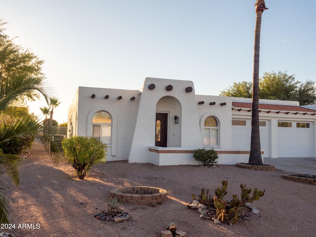 adobe home featuring a garage