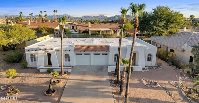 view of front facade with a mountain view and a garage