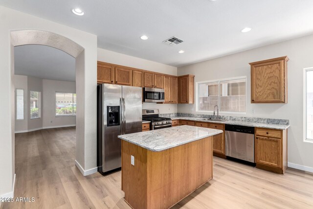 12238 W Monroe St, Avondale, AZ 85323 - kitchen with stainless steel appliances, a sink, a center island, light wood finished floors, and recessed lighting
