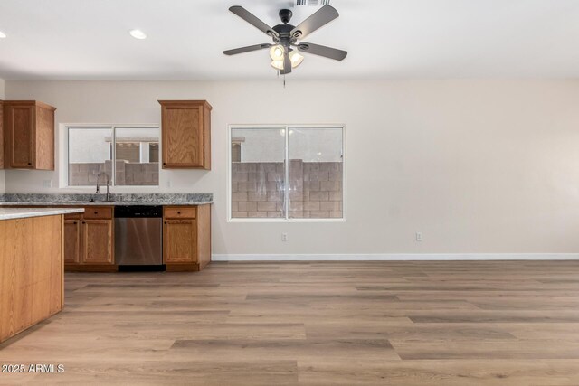 12238 W Monroe St, Avondale, AZ 85323 - kitchen with stainless steel dishwasher, light countertops, a ceiling fan, light wood-style floors, and recessed lighting