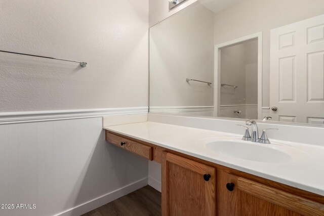 12238 W Monroe St, Avondale, AZ 85323 - bathroom with vanity, wood finished floors, and a wainscoted wall