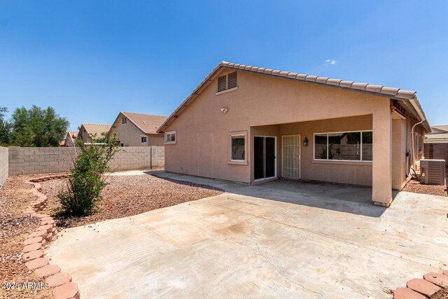 12238 W Monroe St, Avondale, AZ 85323 - back of house with central air condition unit, a fenced backyard, a patio, and stucco siding