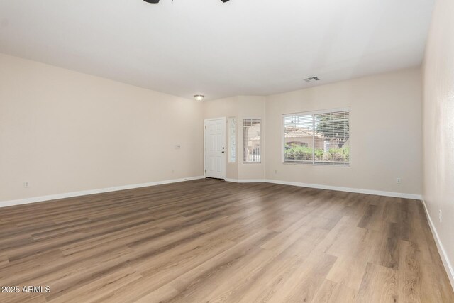 12238 W Monroe St, Avondale, AZ 85323 - unfurnished living room with wood finished floors, baseboards, and a ceiling fan