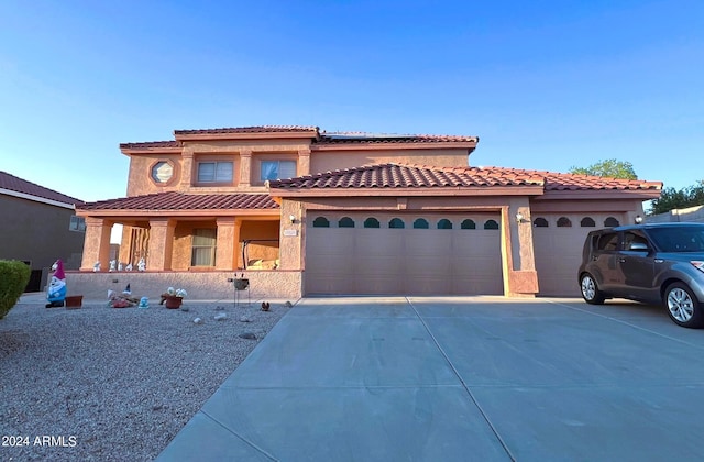 mediterranean / spanish-style home featuring a garage