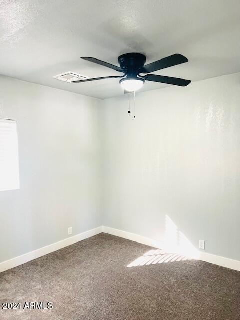 empty room with ceiling fan and carpet floors