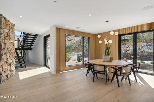 dining room with light wood-type flooring and a chandelier