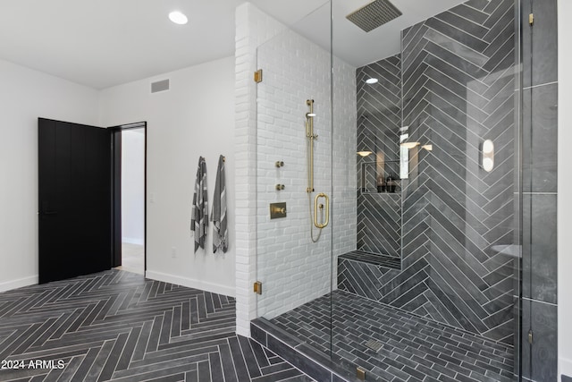 bathroom featuring a shower with door