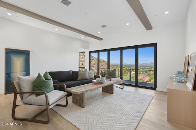 living room with light hardwood / wood-style flooring and beam ceiling