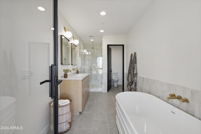 full bathroom with independent shower and bath, toilet, tile patterned flooring, and vanity