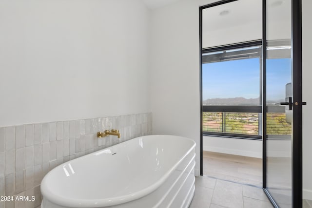 bathroom with a bathing tub and tile patterned flooring