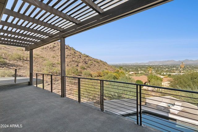 balcony with a mountain view and a pergola