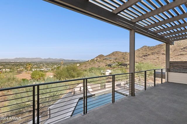 balcony featuring a mountain view and a pergola