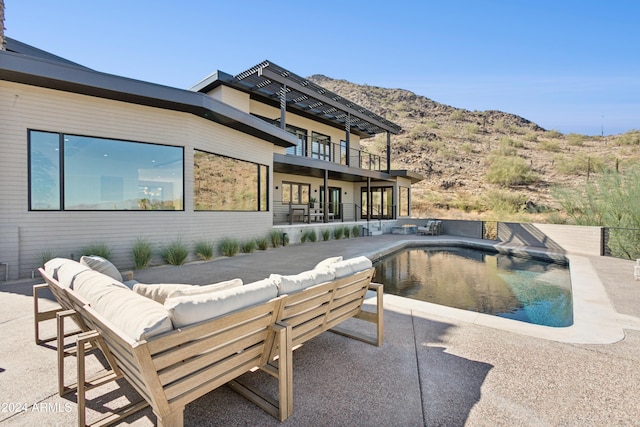 view of pool featuring a mountain view, a patio area, and outdoor lounge area