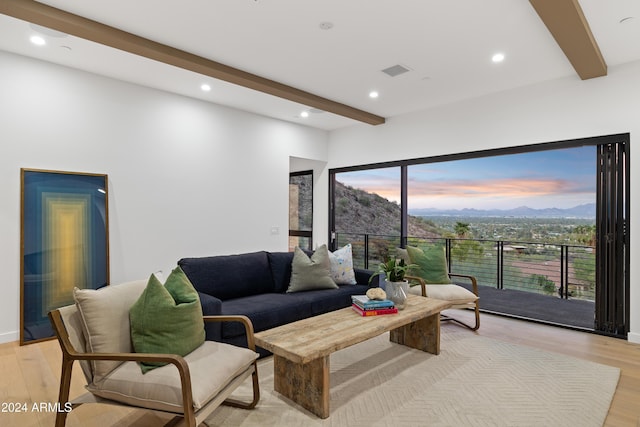 living room with light wood-type flooring, beam ceiling, and a mountain view