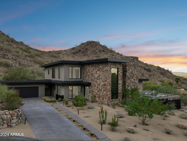 view of front facade featuring a garage and a mountain view