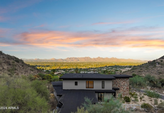 back house at dusk featuring a mountain view