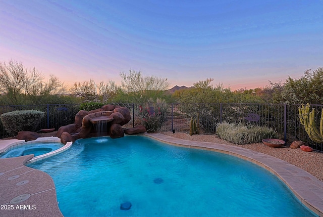 5520 E Desert Forest Trl, Cave Creek, AZ 85331 - pool at dusk featuring a pool with connected hot tub