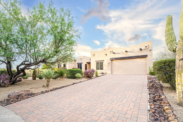 5520 E Desert Forest Trl, Cave Creek, AZ 85331 - pueblo-style house featuring driveway, stucco siding, and a garage