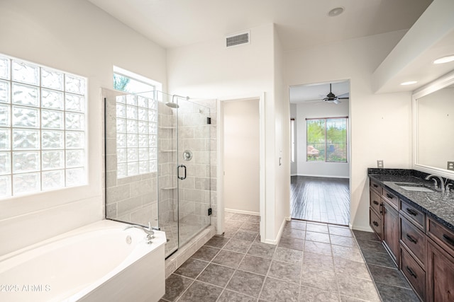 5520 E Desert Forest Trl, Cave Creek, AZ 85331 - full bathroom featuring vanity, a garden tub, a stall shower, a ceiling fan, and baseboards