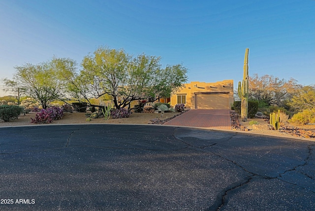 5520 E Desert Forest Trl, Cave Creek, AZ 85331 - pueblo-style home with an attached garage and driveway
