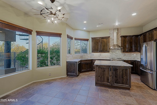 5520 E Desert Forest Trl, Cave Creek, AZ 85331 - kitchen with stainless steel appliances, wall chimney exhaust hood, a sink, ceiling fan, and decorative backsplash