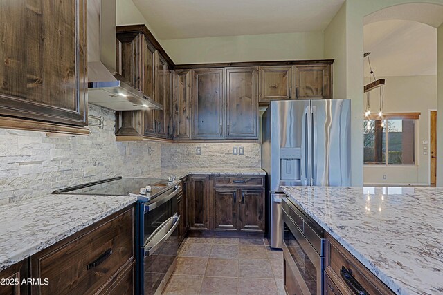 5520 E Desert Forest Trl, Cave Creek, AZ 85331 - kitchen with stainless steel appliances, wall chimney range hood, arched walkways, and light stone counters