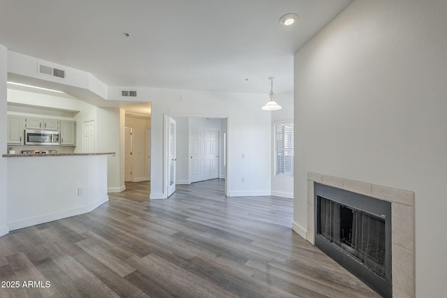 600 W Grove Pkwy Unit 2188, Tempe, AZ 85283 - unfurnished living room featuring dark wood-type flooring and a tile fireplace