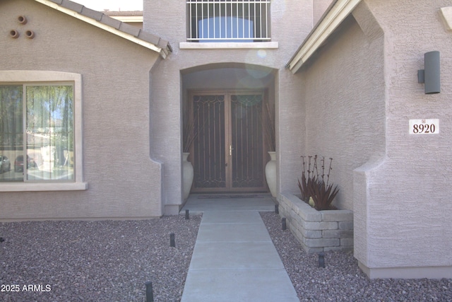 8920 S 40th Ln, Laveen, AZ 85339 - view of exterior entry featuring stucco siding and a balcony
