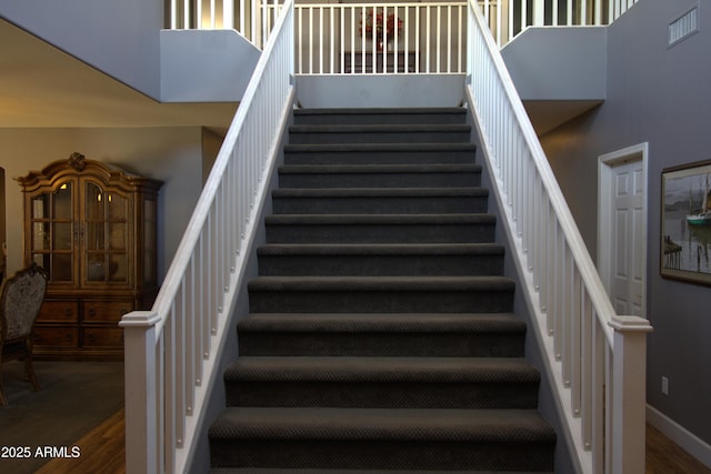 8920 S 40th Ln, Laveen, AZ 85339 - staircase with a towering ceiling, wood finished floors, and baseboards