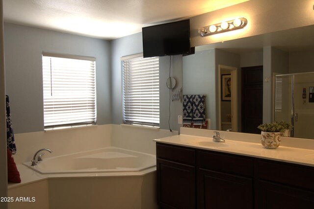 8920 S 40th Ln, Laveen, AZ 85339 - bathroom with a garden tub, double vanity, a shower stall, and toilet