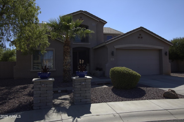 8920 S 40th Ln, Laveen, AZ 85339 - view of front of house featuring a garage, stucco siding, and driveway