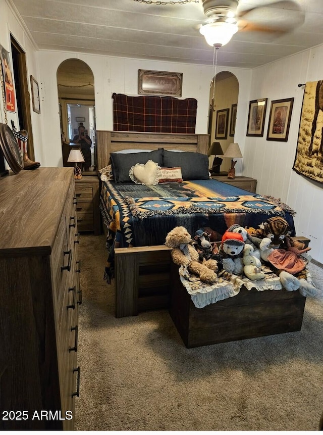 8920 S 40th Ln, Laveen, AZ 85339 - bedroom with carpet flooring, arched walkways, wood walls, and a ceiling fan