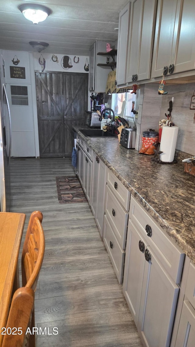 8920 S 40th Ln, Laveen, AZ 85339 - kitchen with a sink, light wood-type flooring, backsplash, and stainless steel fridge
