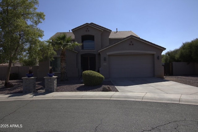 8920 S 40th Ln, Laveen, AZ 85339 - mediterranean / spanish house featuring a garage, stucco siding, and concrete driveway