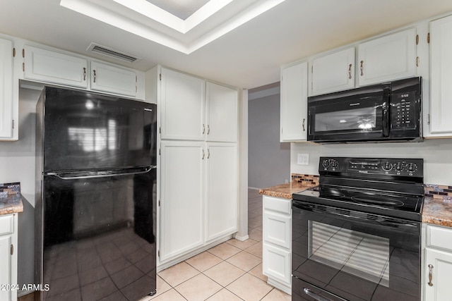 kitchen with light stone countertops, black appliances, white cabinetry, and light tile patterned floors