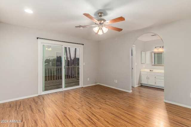 unfurnished bedroom featuring connected bathroom, ceiling fan, light wood-type flooring, and access to exterior