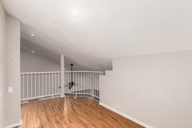 bonus room with vaulted ceiling and hardwood / wood-style flooring