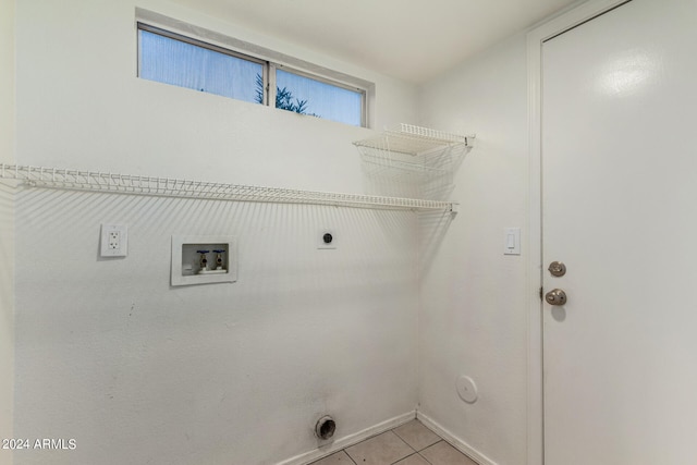 clothes washing area with gas dryer hookup, hookup for a washing machine, light tile patterned flooring, and electric dryer hookup