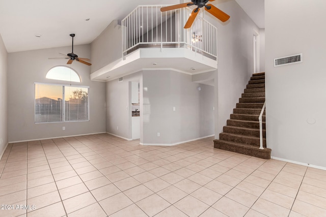 unfurnished living room featuring light tile patterned flooring, high vaulted ceiling, and ceiling fan