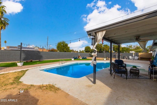 view of swimming pool featuring ceiling fan and a patio