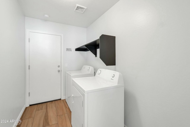 962 W Lindbergh Ave, Coolidge, AZ 85128 - clothes washing area featuring light hardwood / wood-style flooring and washer and dryer