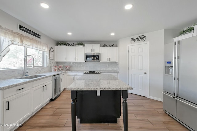 962 W Lindbergh Ave, Coolidge, AZ 85128 - kitchen featuring light stone counters, stainless steel appliances, beverage cooler, white cabinets, and a center island