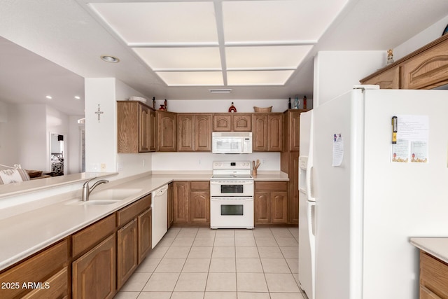 kitchen with sink, white appliances, and light tile patterned floors